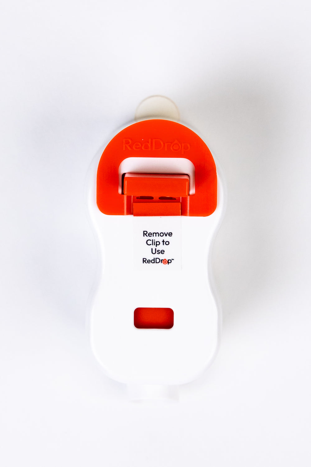 Hand holding RedDrop ONE capillary blood collection device with attached tube